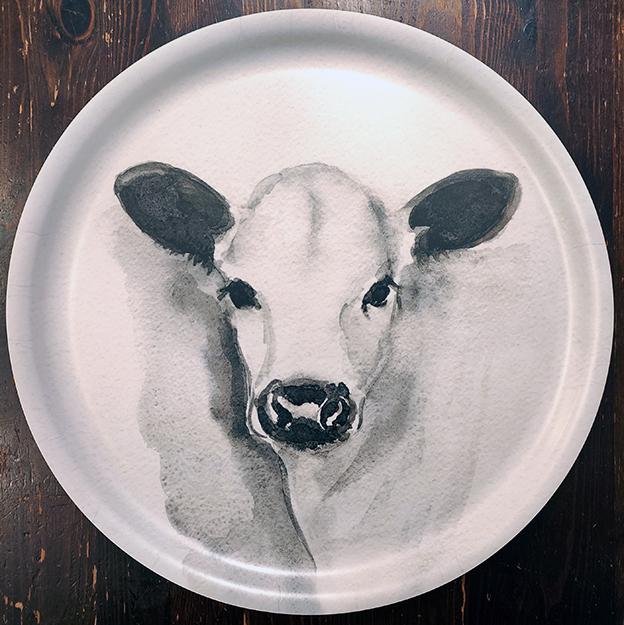 Ateljee Lumimetsä Lapinlehmävasikka – pyöreä käsinmaalattu tarjotin Posiolta, Lapinlehmä-kuvituksella.