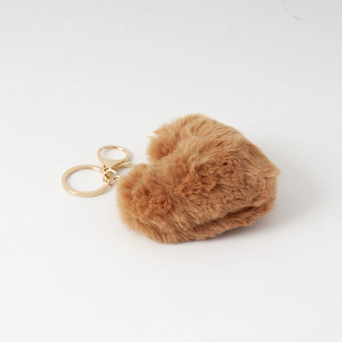 Pehmeä sydämenmuotoinen laukkukoru keinoturkiksesta, kullanväriset metalliyksityiskohdat ja karbiinikoukku laukkuun tai avaimiin