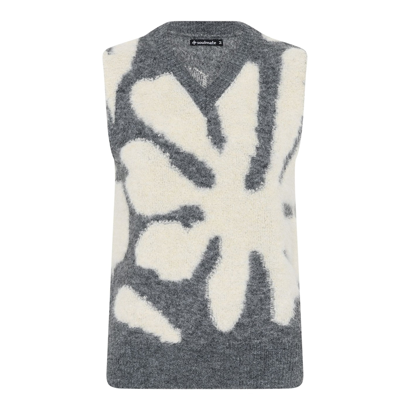 Monice neuleliivi Soulmate, pehmeä ja lämmin liivi harmaalla pohjalla ja luonnonvalkoisella kukkakuviolla – monikäyttöinen ja tyylikäs kerrospukeutumiseen.