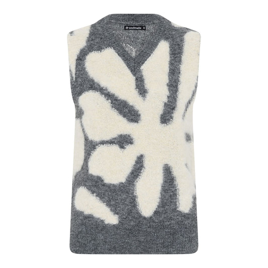 Monice neuleliivi Soulmate, pehmeä ja lämmin liivi harmaalla pohjalla ja luonnonvalkoisella kukkakuviolla – monikäyttöinen ja tyylikäs kerrospukeutumiseen.