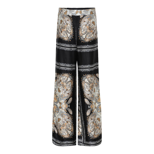 Universe 2 housut Soulmate, mustat leveälahkeiset satiinihousut ylellisellä kuosilla – elegantit ja mukavat housut juhlaan ja arkeen.